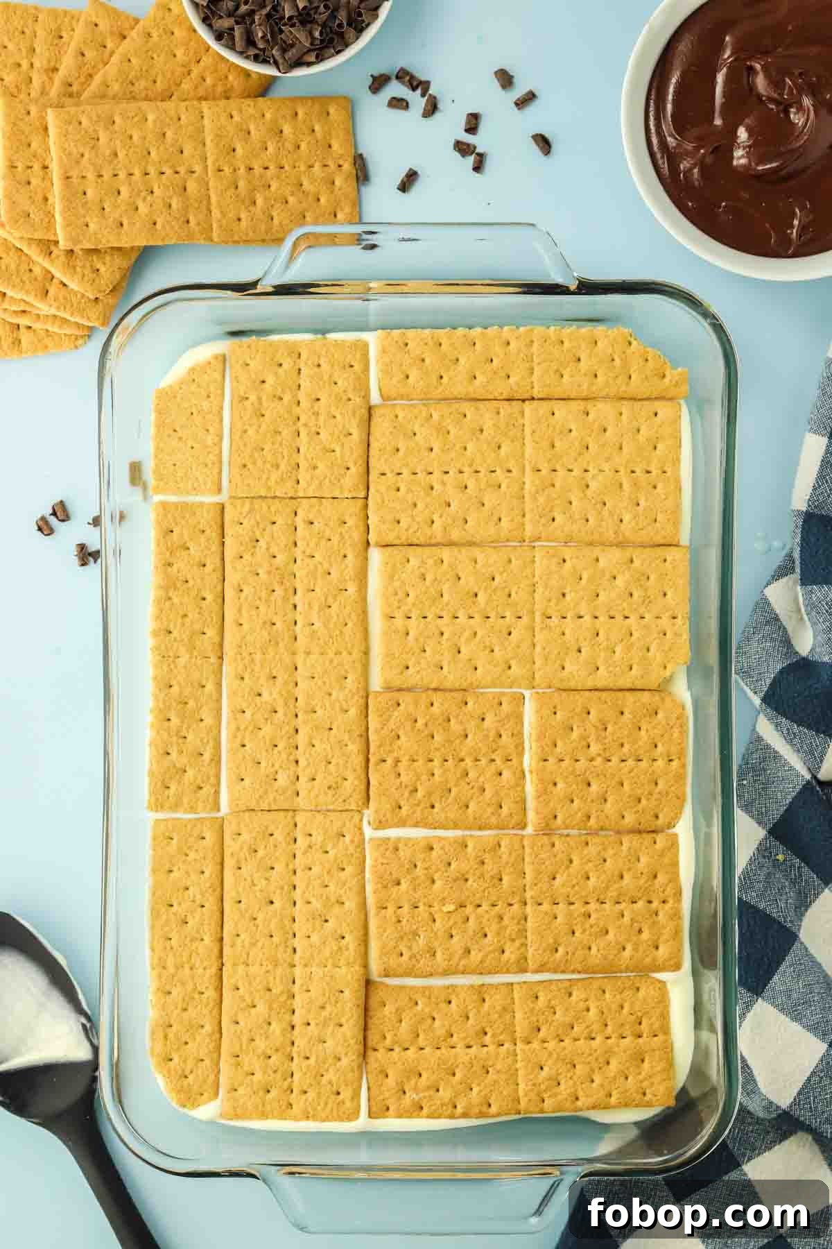 No-Bake Chocolate Eclair Cake Recipe (No Oven Needed) 8 Layer of graham crackers arranged in 9x13 inch baking pan - Hostess At Heart