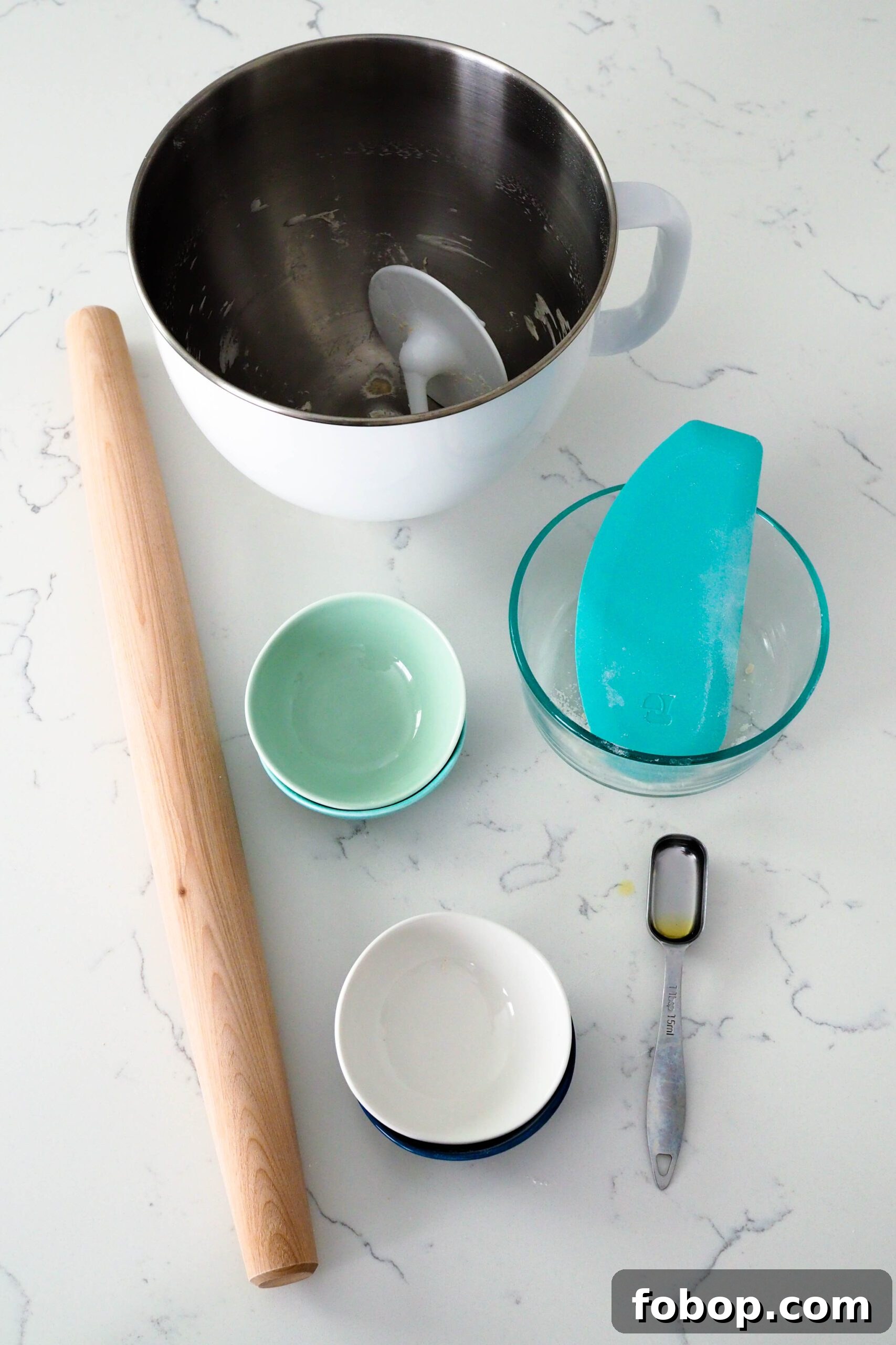 A collection of bowls used in making thin crust pizza dough.