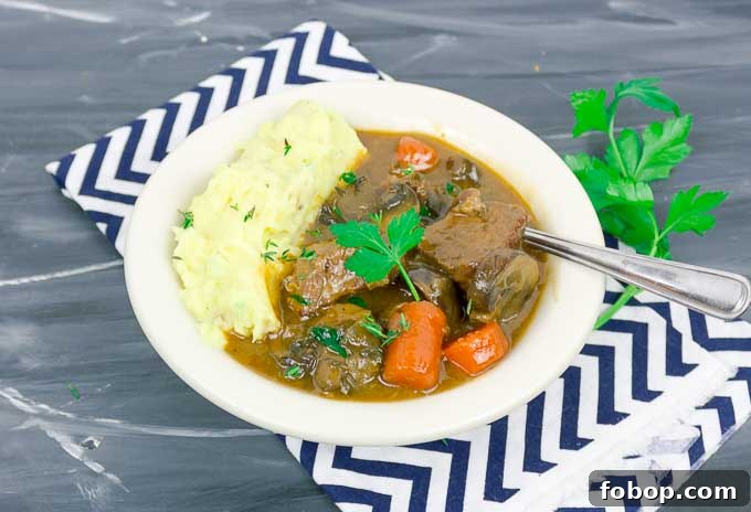 Beef and Guinness Stew with Homemade Guinness Beer Bread 8 Beef and Guinness Stew in white bowl with mashed potatoes