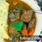 Beef and Guinness Stew with Homemade Guinness Beer Bread 10 Beef and Guinness Stew in white bowl with mashed potatoes