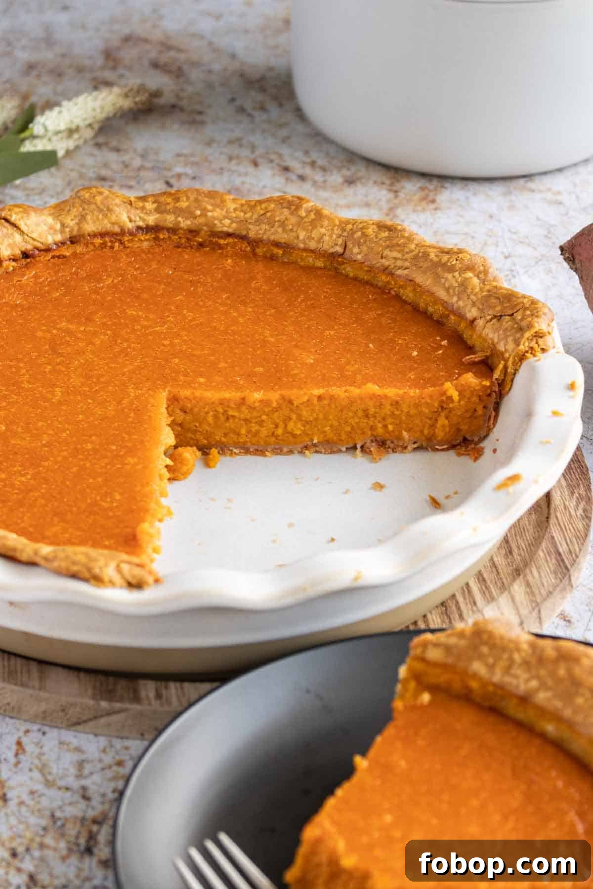 Ultimate Homemade Sweet Potato Pie Recipe for Any Occasion 2 Sweet potato pie with a slice taken out.
