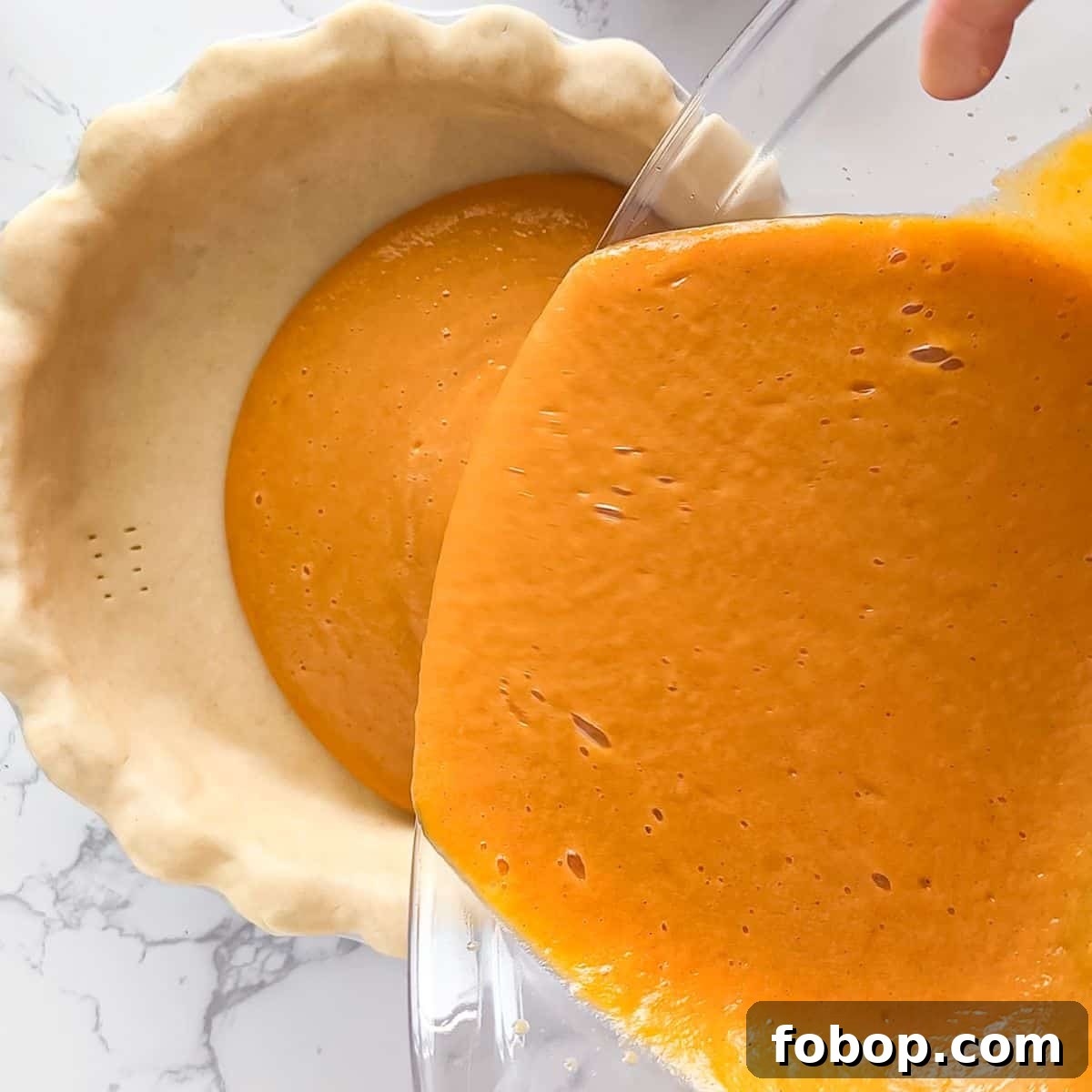 Ultimate Homemade Sweet Potato Pie Recipe for Any Occasion 7 Pouring the sweet potato pie mixture into the crust.