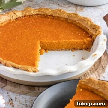 Ultimate Homemade Sweet Potato Pie Recipe for Any Occasion 9 Cooked sweet potato pie with slice removed.