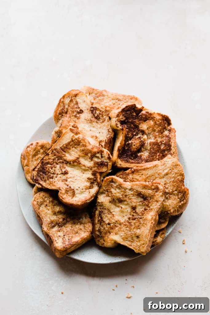A plate of golden brown french toast slices 