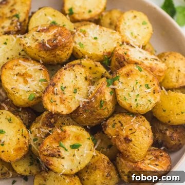 Perfectly golden roasted baby potatoes served on a plate