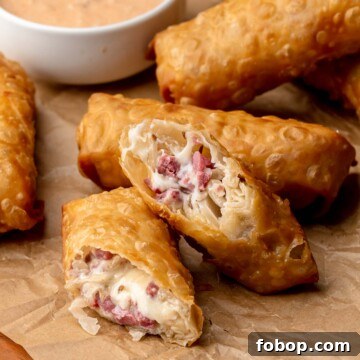 Reuben egg rolls cut in half to expose the center.