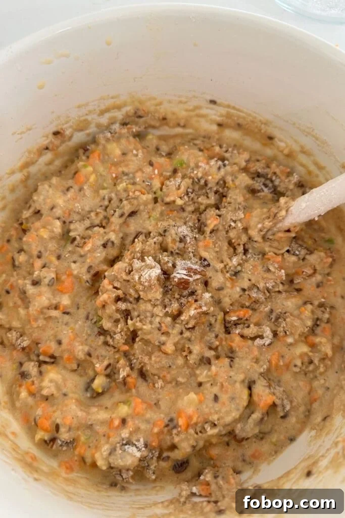 Sourdough Morning Glory Muffin Mixture that has just been brought together. You can still see some dry flour in the mixture.