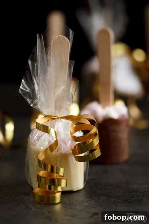 Hot chocolate stick wrapped in cellophane and tied with gold curling ribbon