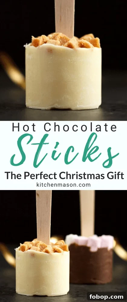 Hot chocolate sticks topped with fudge pieces and marshmallows surrounded by gold curling ribbon