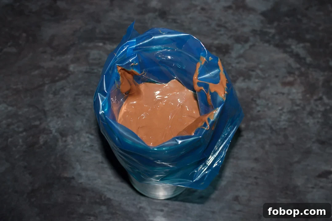 Melted milk chocolate in a disposable piping bag