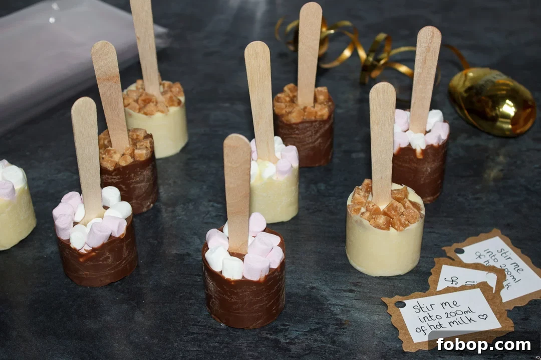 Milk and white hot chocolate sticks with tags, cellophane and curling ribbon, ready to be wrapped.