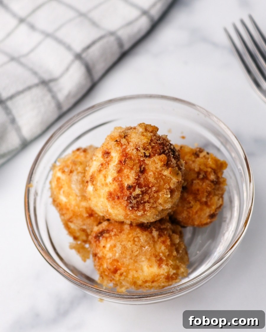 Crispy Air Fryer Carnivore Cream Cheese Bites 3 Air Fryer Crispy Carnivore Cream Cheese Bites with kitchen towel and fork