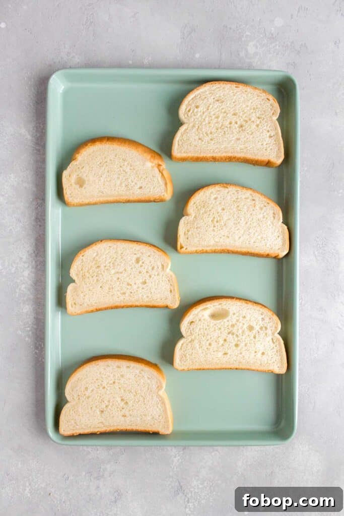 Oven Toasted Bread: How to Toast Slices Perfectly Every Time 4 Overhead view of a sheet pan with sliced bread.