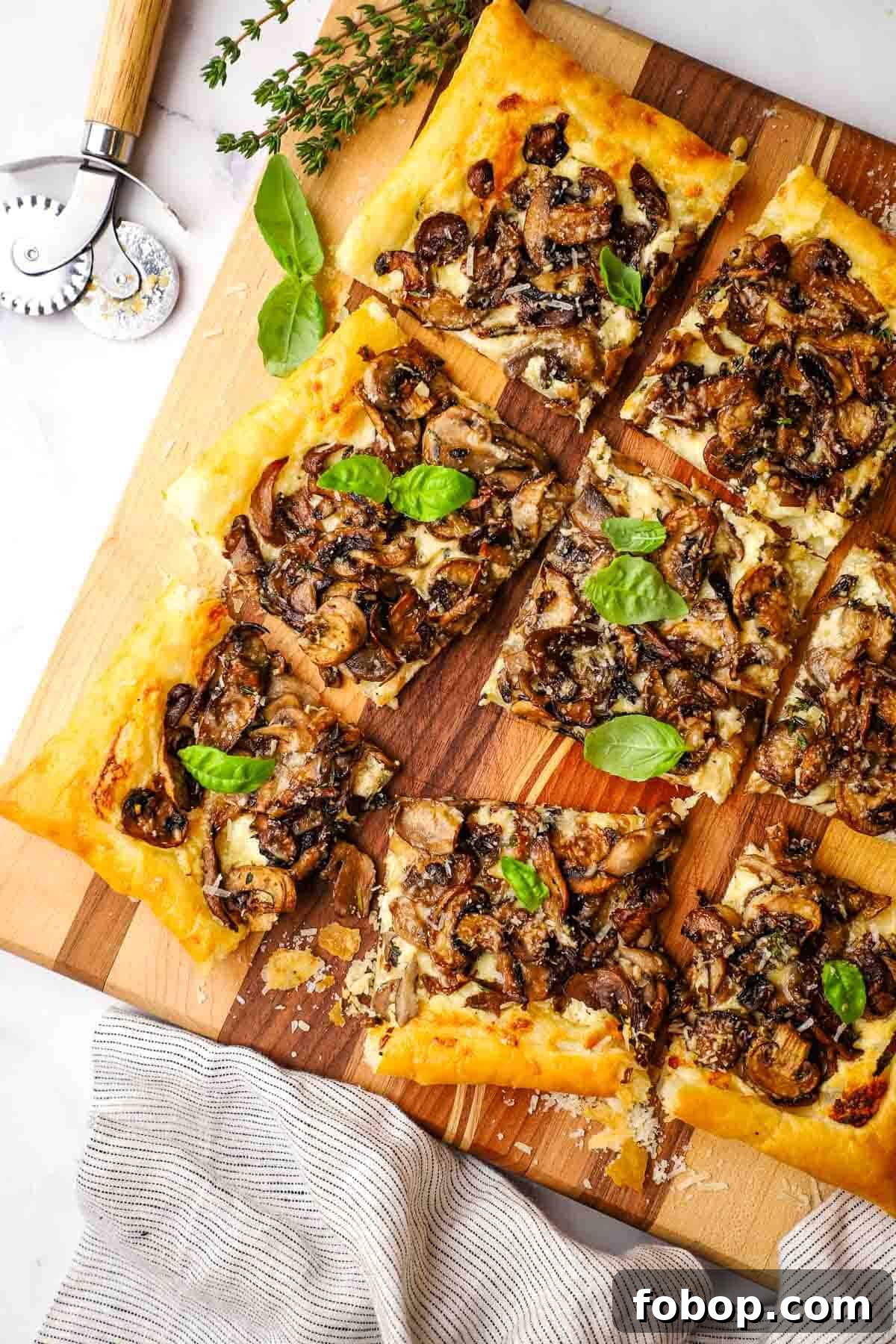 Savory Mushroom Tart with Caramelized Onions and Thyme 2 overhead view of mushroom tart cut into pieces.