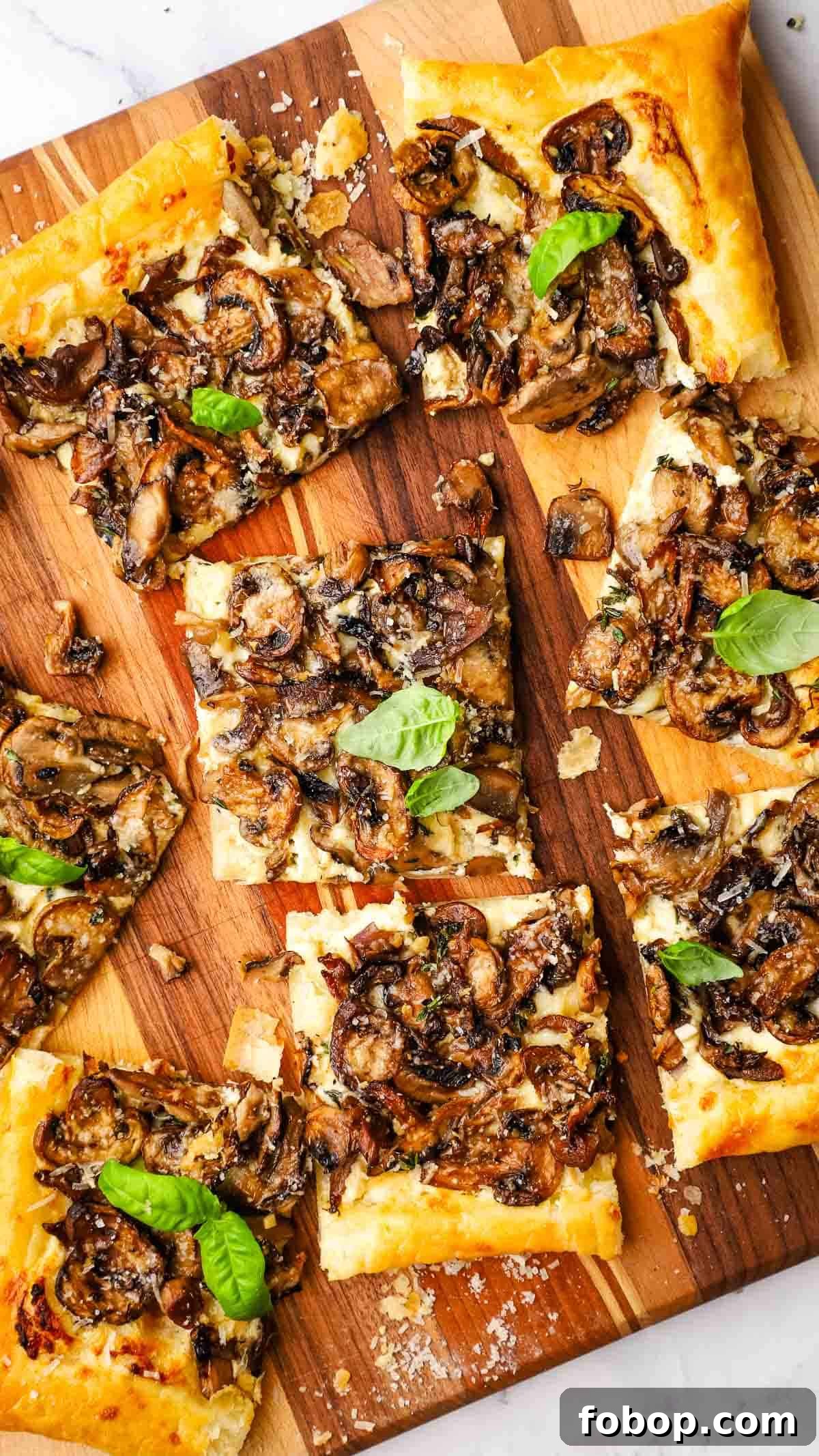 Savory Mushroom Tart with Caramelized Onions and Thyme 7 overhead view of mushroom tart cut into pieces.