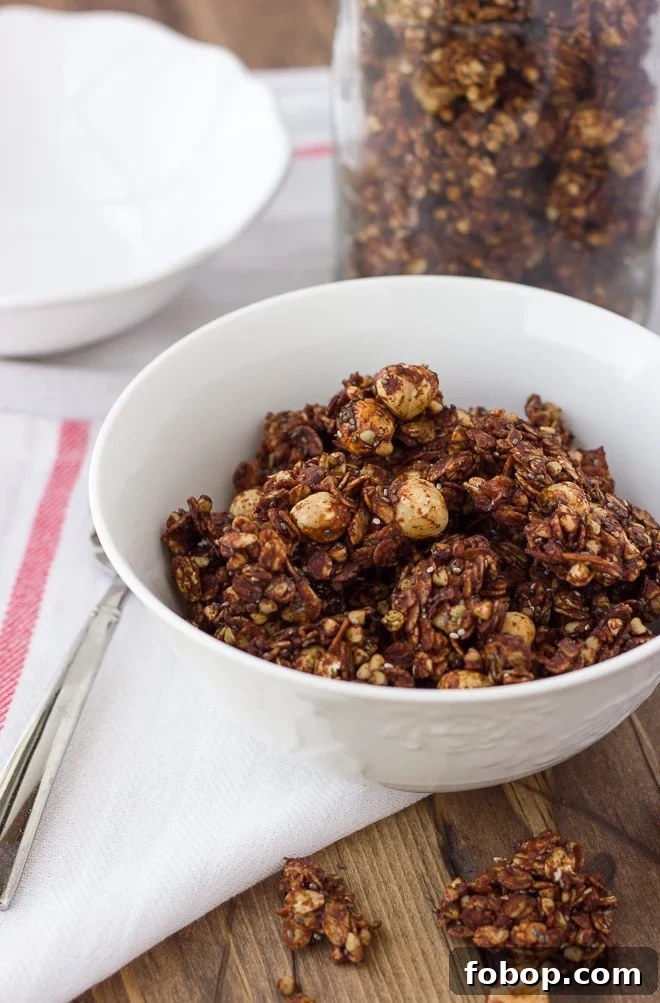 Chocolate Hazelnut Granola — Gluten Free & Dairy Free Recipe 2 chocolate granola in white bowl with white dish towel and spoon