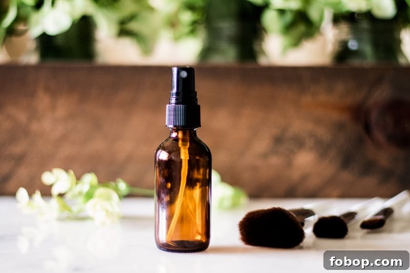Make Your Own Natural Makeup: Simple DIY Recipes and Tips 13 Homemade makeup setting spray for dry skin with flower pedals and wooden background.