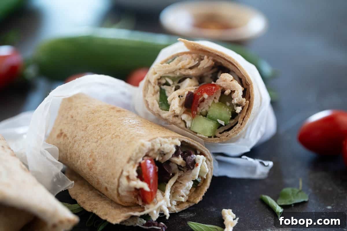Mediterranean Chicken Wrap Recipe with Tzatziki and Feta 2 Greek Chicken Wrap cut in half to show interior.