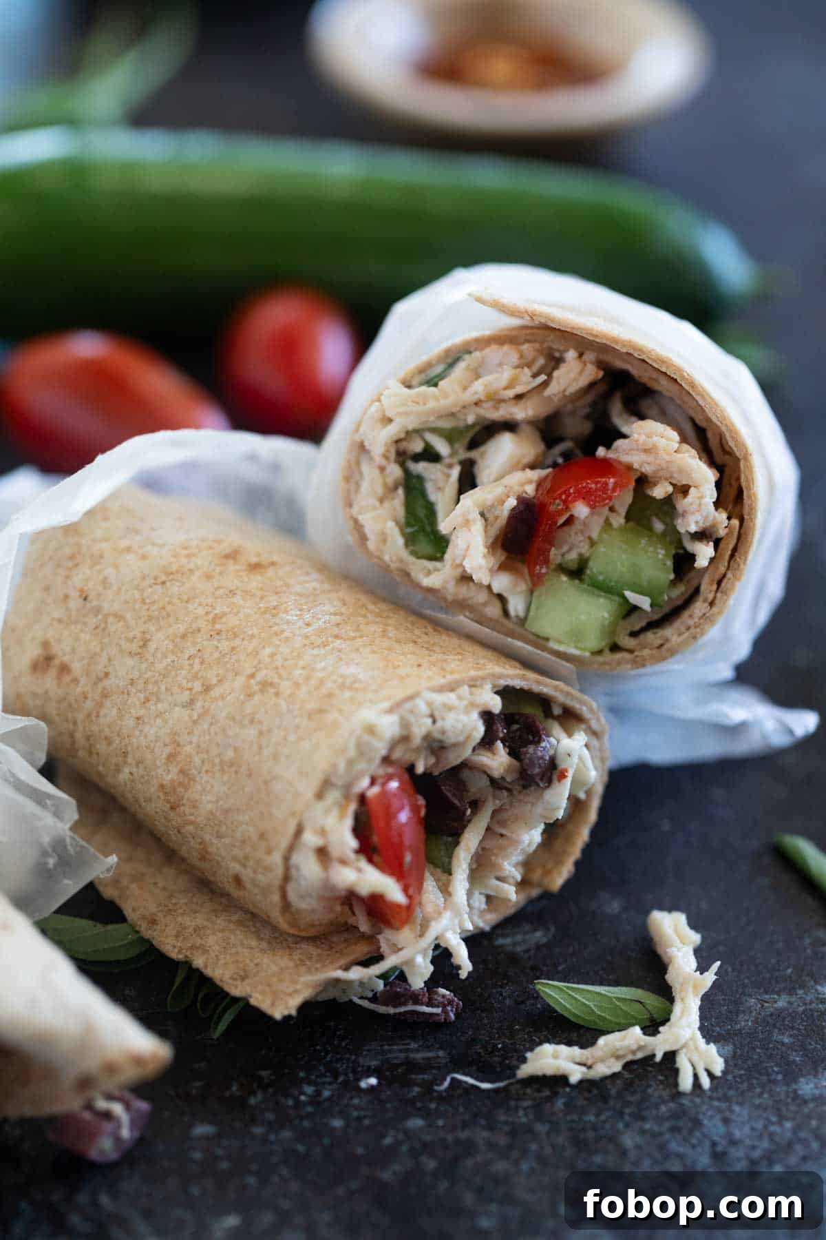 Mediterranean Chicken Wrap Recipe with Tzatziki and Feta 7 Greek Chicken Wrap cut in half and stacked.