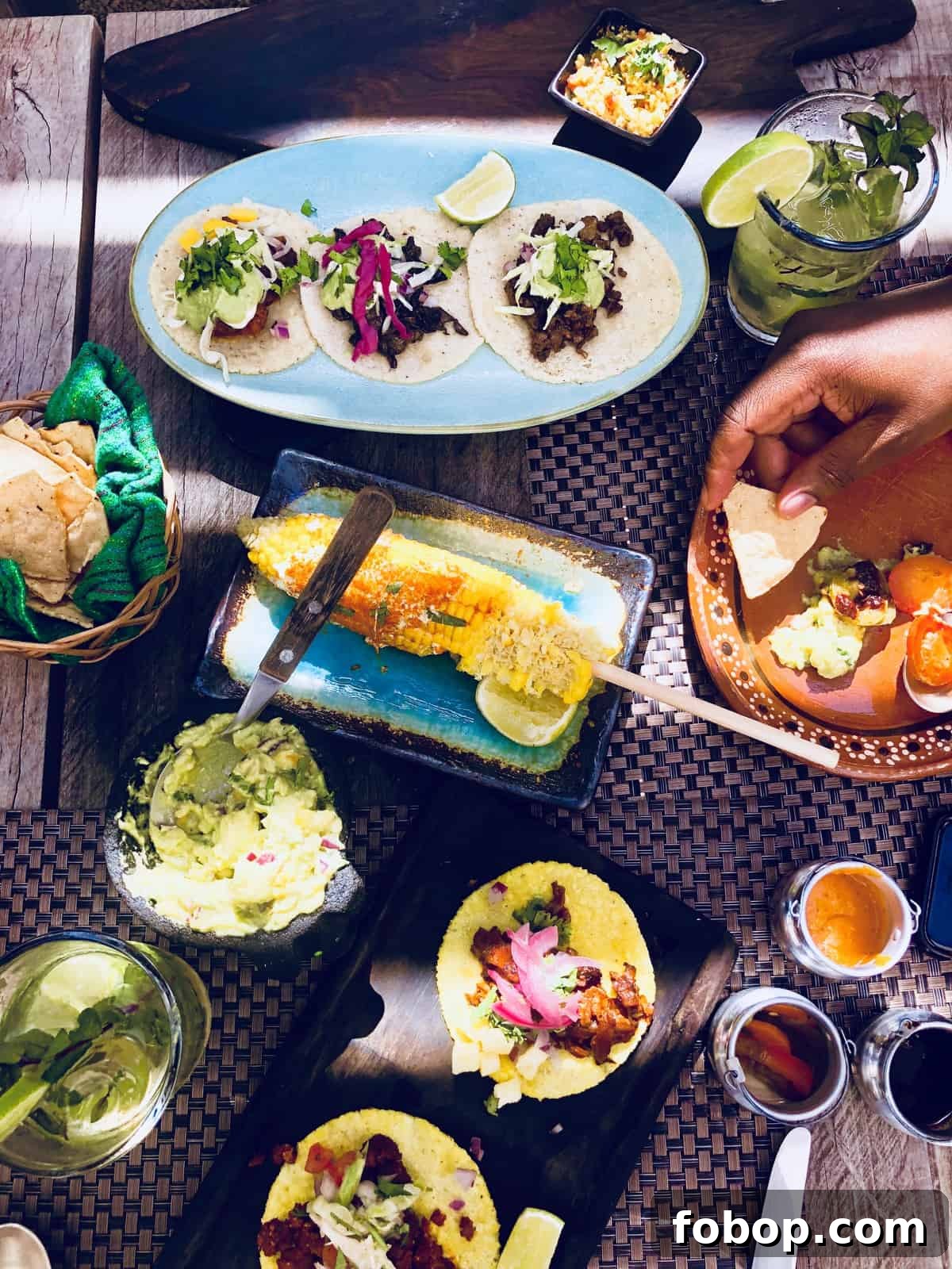 Tulum Travel Guide: Top Eats, Hotels, and Must-See Activities 8 Top down view of various delicious plates of food.
