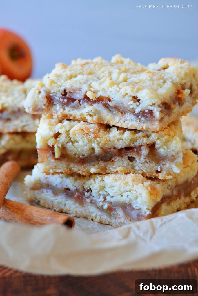 a triple stack tower of apple pie crumble bars on brown parchment