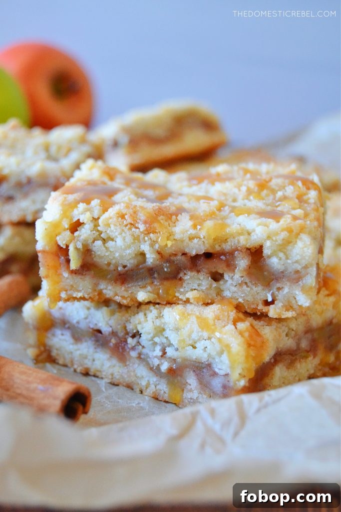 a double stack of apple pie crumble bars drizzled with caramel sauce