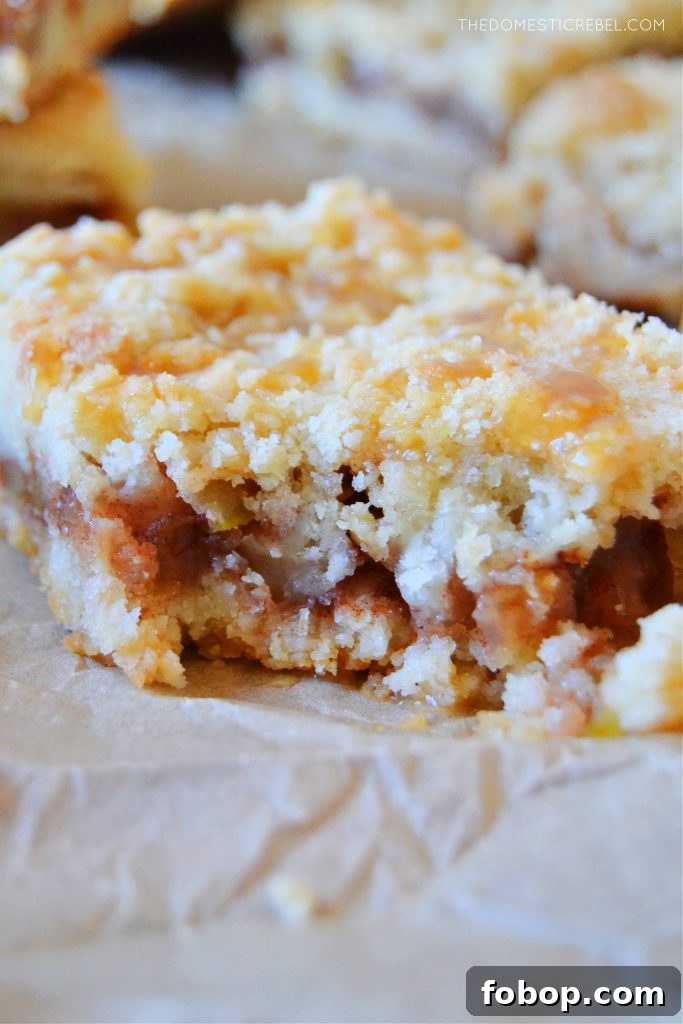 closeup of an apple pie crumble bar with a bite missing