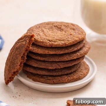 Small-Batch Brown Sugar Cookie Recipe for Perfect Soft Bites 14 A stack of brown sugar cookies on a plate next to a glass of milk.