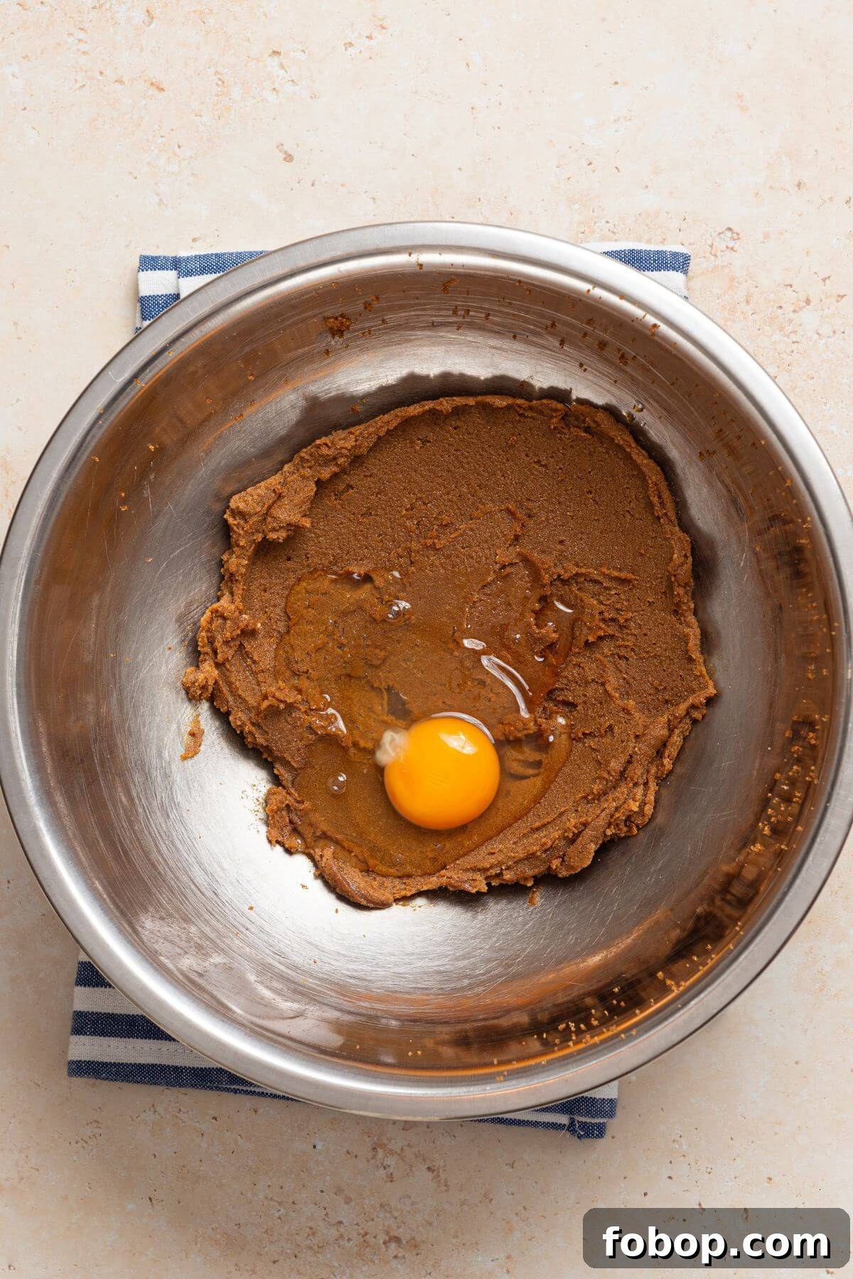 Small-Batch Brown Sugar Cookie Recipe for Perfect Soft Bites 6 A bowl with brown sugar and butter mixture with an egg.