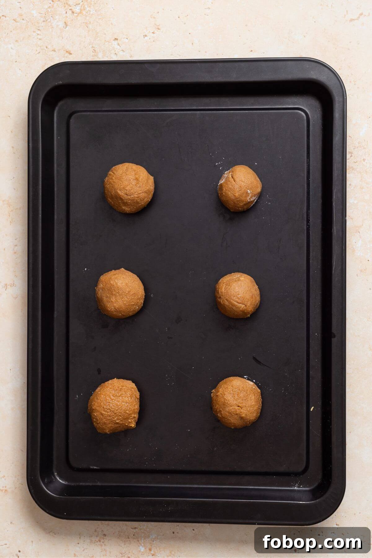 Small-Batch Brown Sugar Cookie Recipe for Perfect Soft Bites 10 A baking tray with cookie dough balls on it.