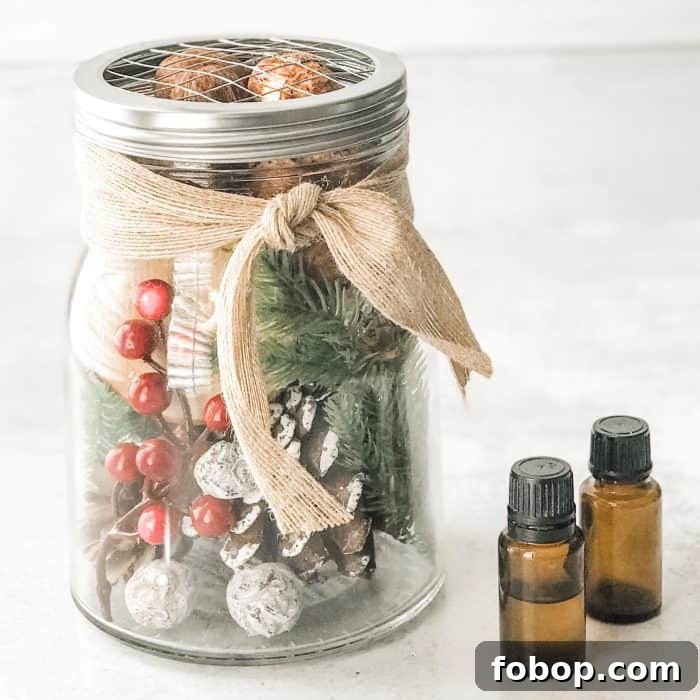 Christmas Potpourri Diffuser Ideas for Cozy Holiday Aromas 3 Christmas decor with berries, greenery, and pinecones used as an essential oil diffuser