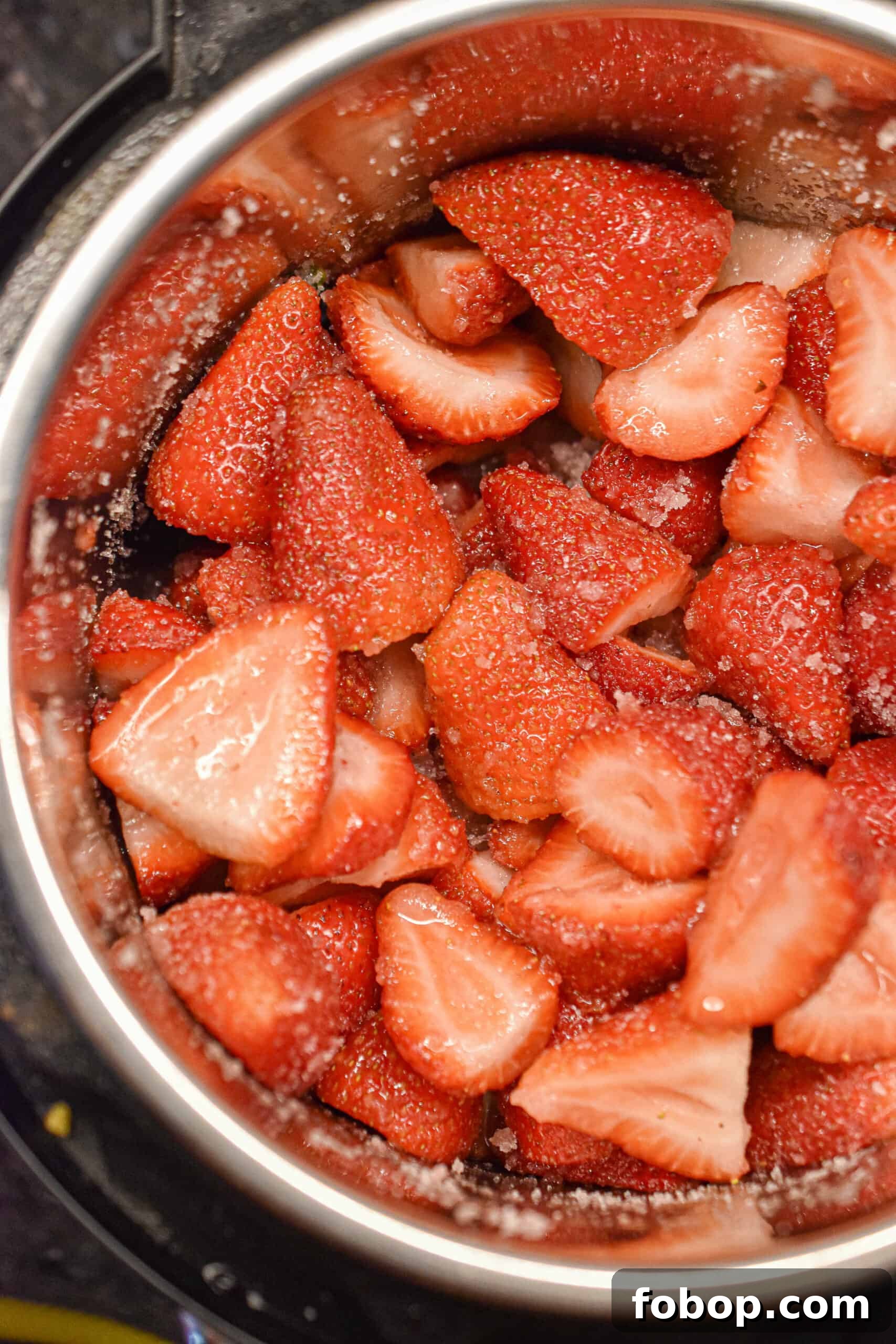 Add strawberries and sugar to the instant pot for the 3 ingredient instant pot strawberry jam