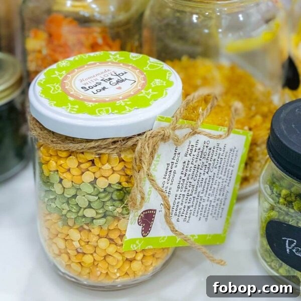 Jar of split pea soup mix with dry ingredients in the background.