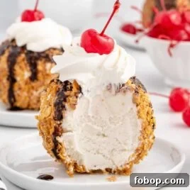 Authentic Mexican Fried Ice Cream Recipe: Crispy Cinnamon Sundae 13 a close up shot of Mexican Ice Cream on a plate with a piece taken out