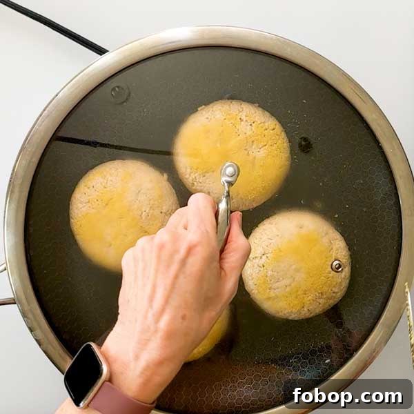 Placing a lid on the skillet to trap in steam.