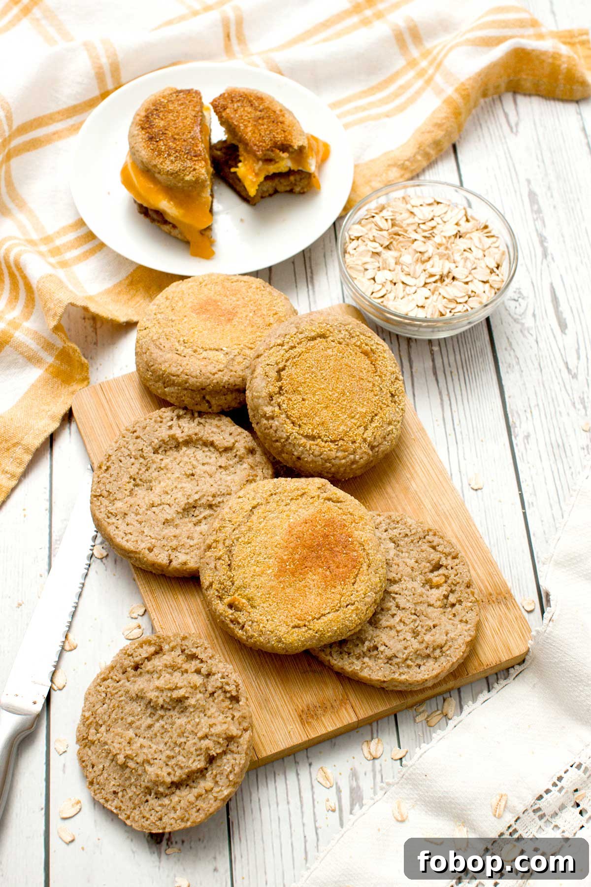 Oat flour English muffins on a cutting board.