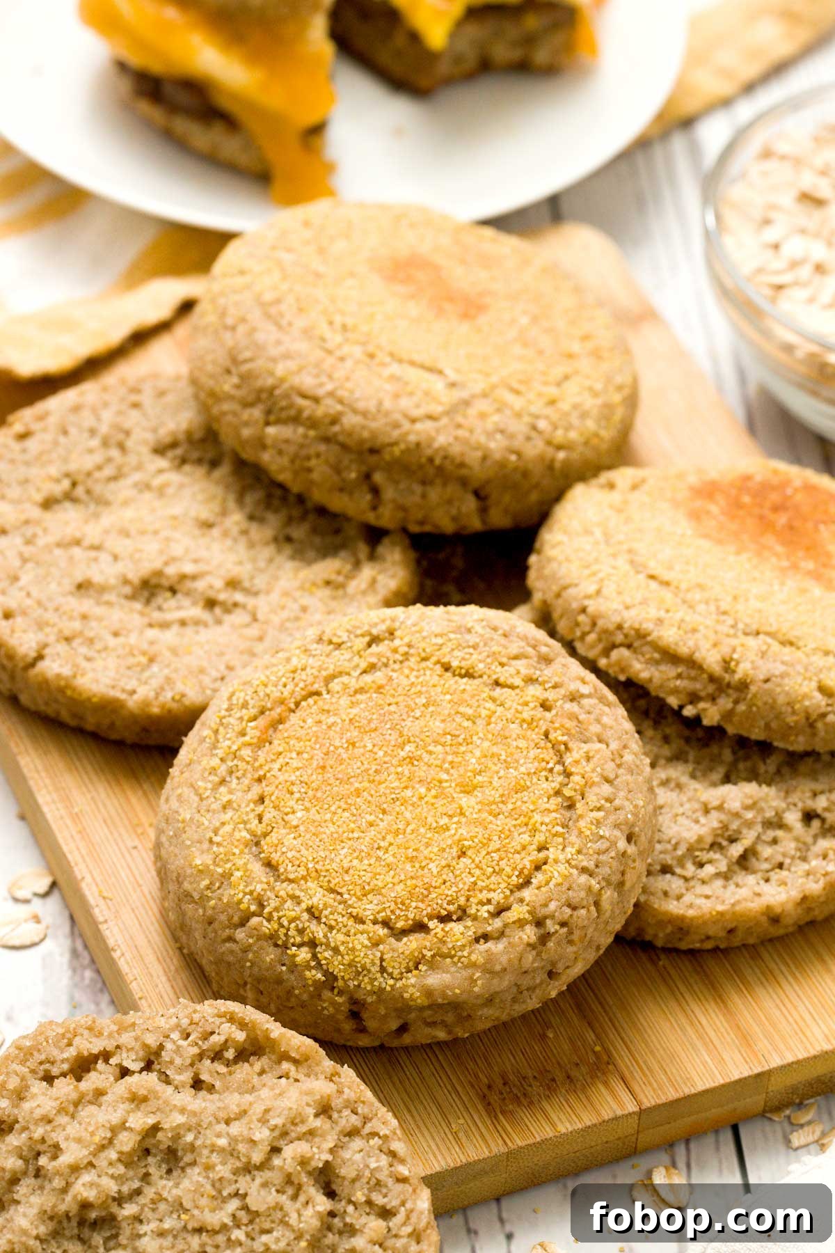 Oat flour English muffins on a cutting board.
