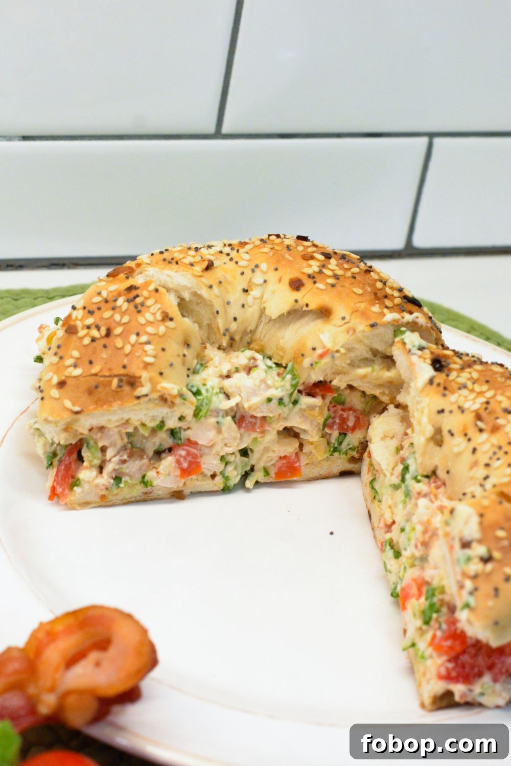 These chopped chicken bacon ranch salad bagels are a quick, no-cook lunch made with rotisserie chicken, crispy bacon, tomatoes, lettuce, and ranch cream cheese. Ready in 15 minutes!