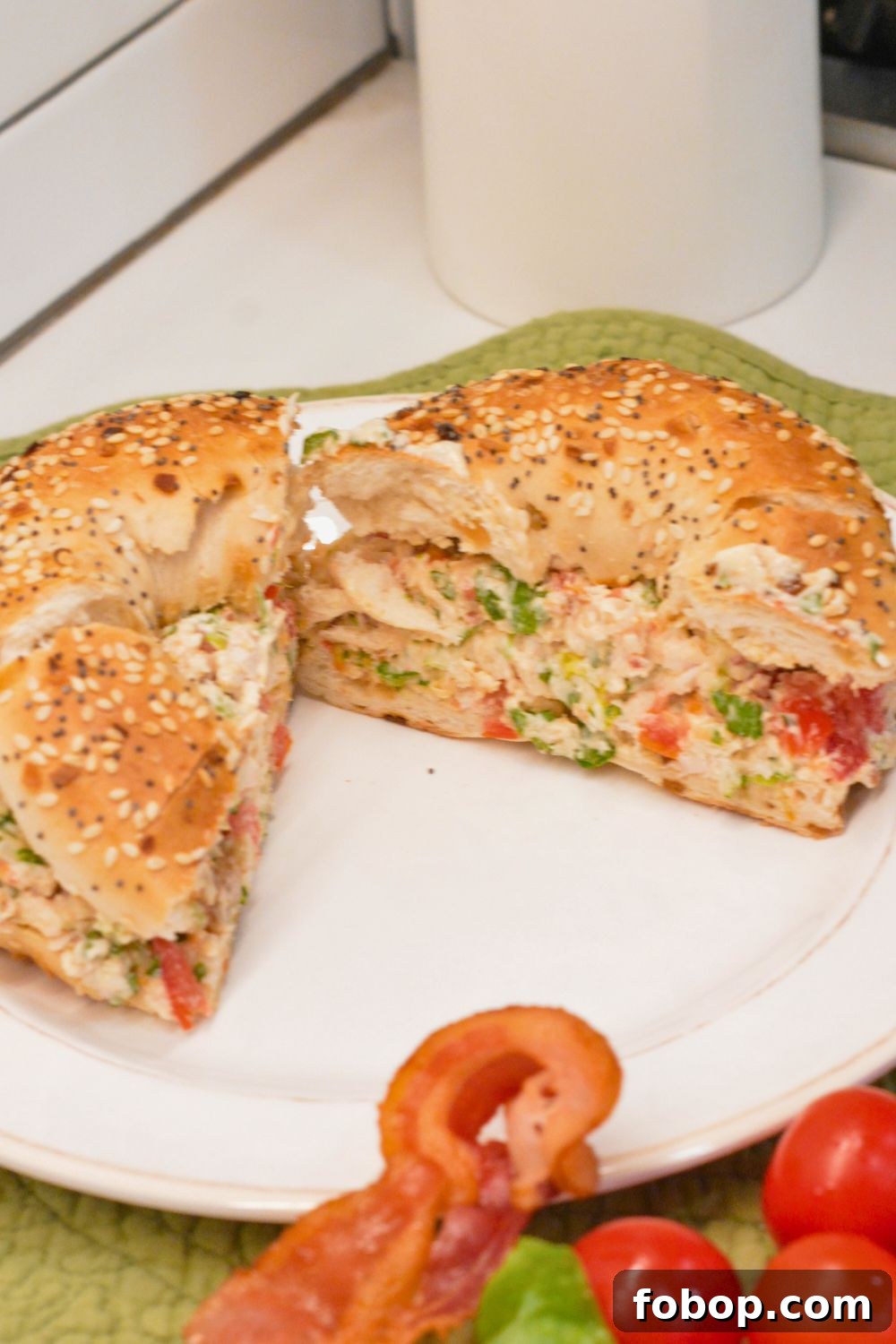 These chopped chicken bacon ranch salad bagels are a quick, no-cook lunch made with rotisserie chicken, crispy bacon, tomatoes, lettuce, and ranch cream cheese. Ready in 15 minutes!