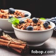 Two bowls of low carb granola cereal with berries.