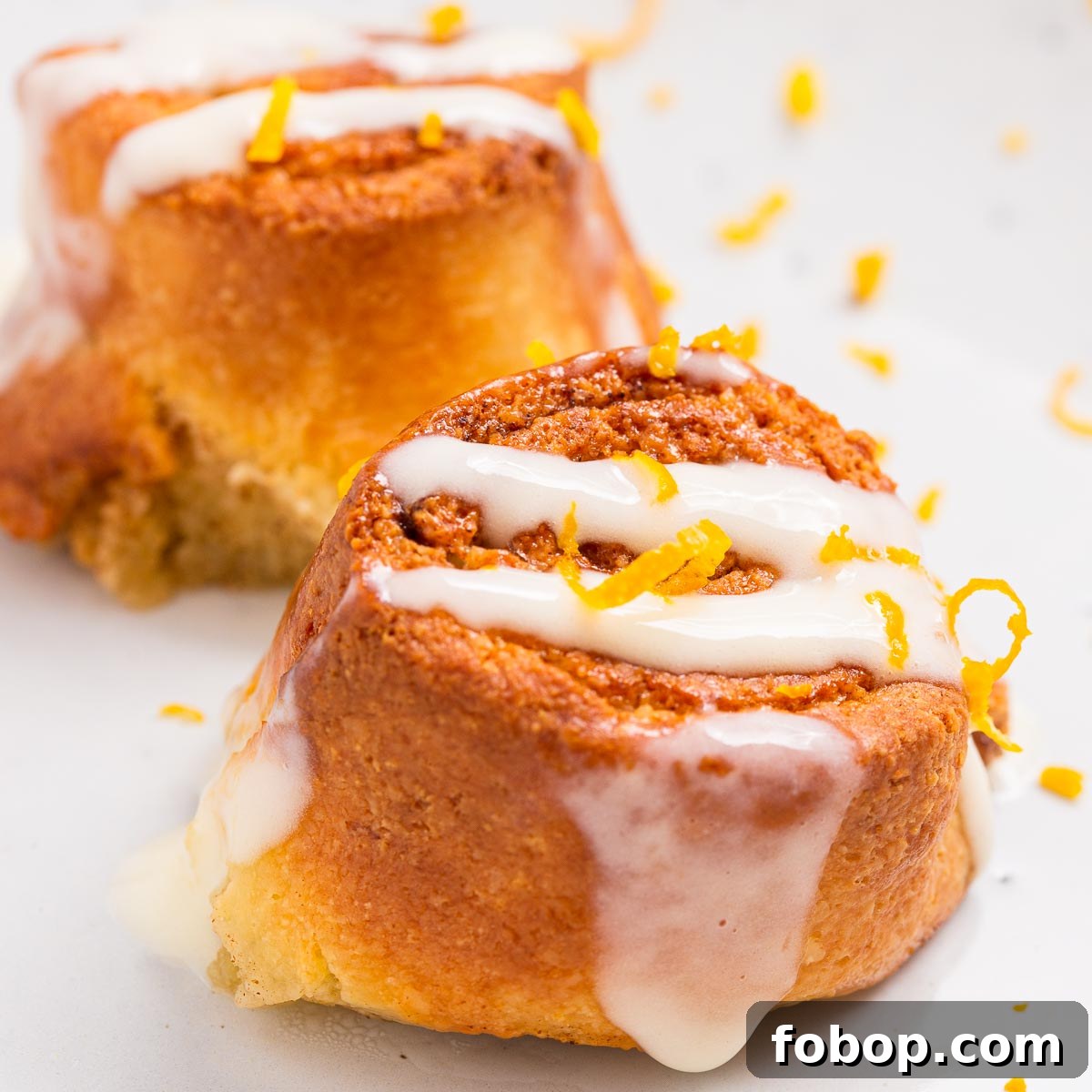 Two iced air fried cinnamon rolls.