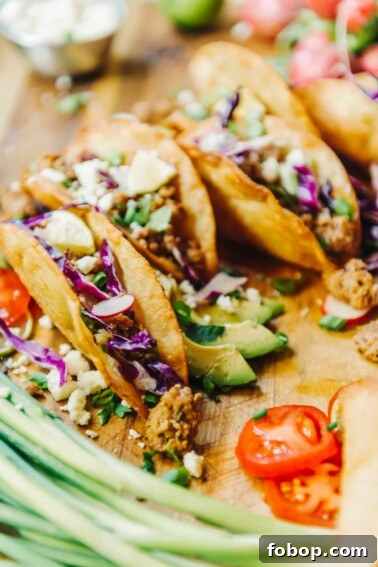 Authentic Mexican Pork Carnitas Recipe for Tender, Crispy Meat 5 crispy fried tacos filled with ground pork and fresh veggies