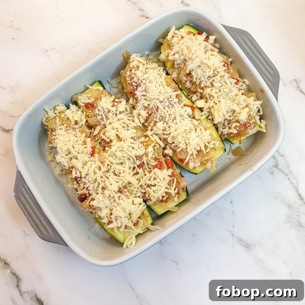 4 cabbage stuffed courgettes topped with cheese and breadcrumbs.