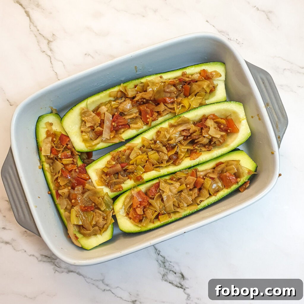 4 hollowed courgettes stuffed with cabbage mixture.