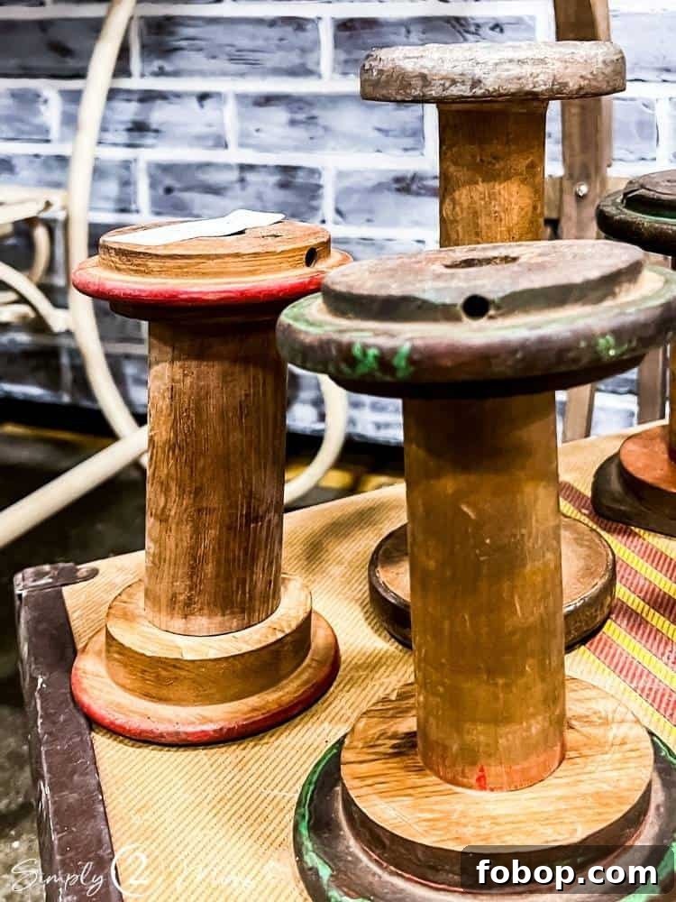 three large wood spools on vintage box