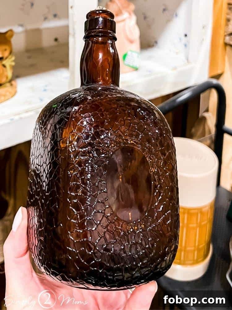 AnnMarie holding textured amber bottle in hand at antique store