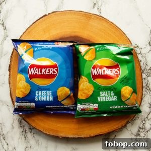 overhead shot of two packet of crisps on wooden board