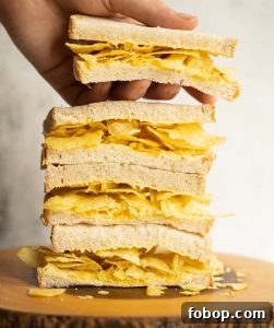 4 crisp sandwich halves stacked on each other with hand grabbing the top one