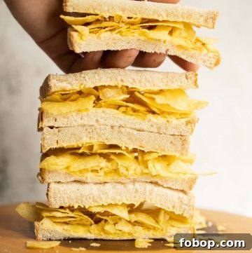 4 crisp sandwich halves stacked on each other with hand grabbing the top one