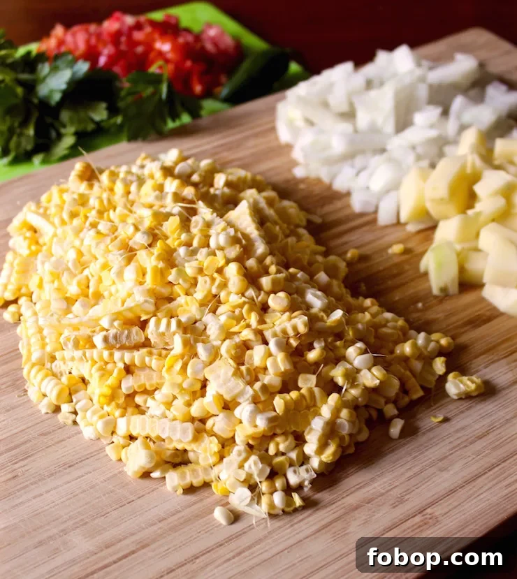 Creamy Summer Corn Chowder Recipe with Fresh Corn and Herbs 3 Prepped ingredients cut up on cutting board.